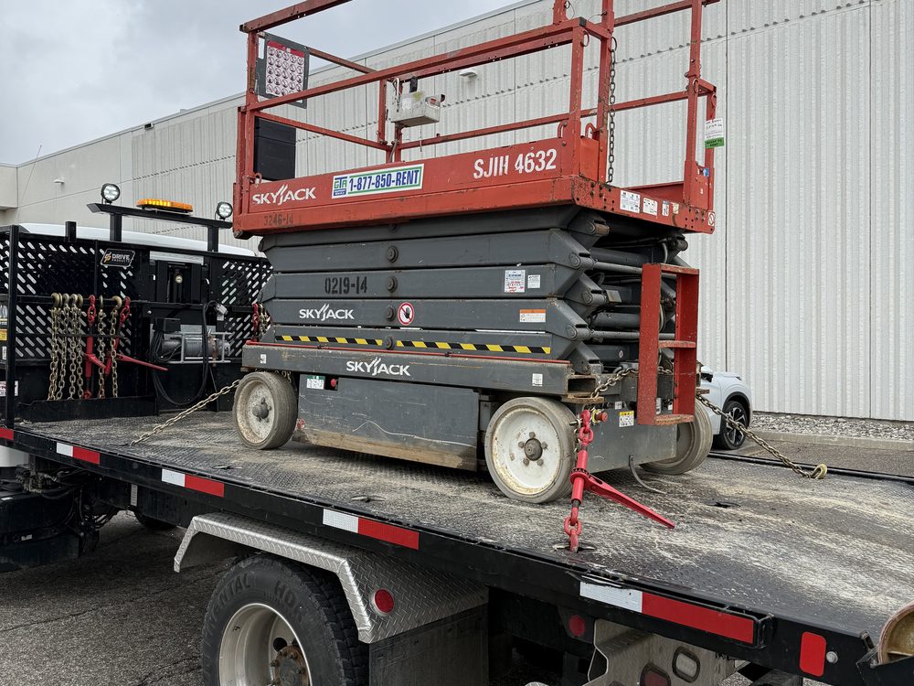 A scissor lift loaded on the GTA delivery trailer