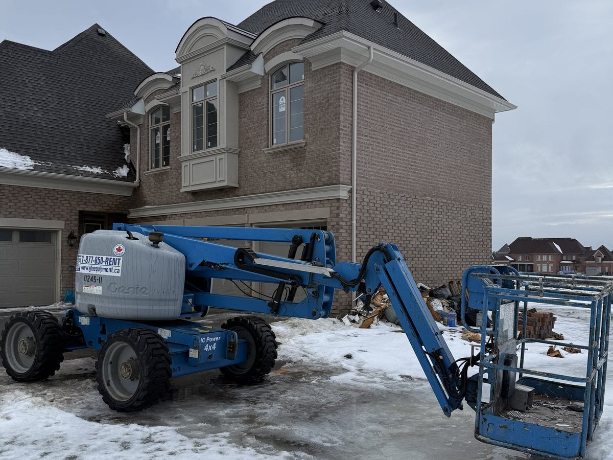 Genie articulating boom lift from GTA Equipment Rentals working on a residential build in the west GTA
