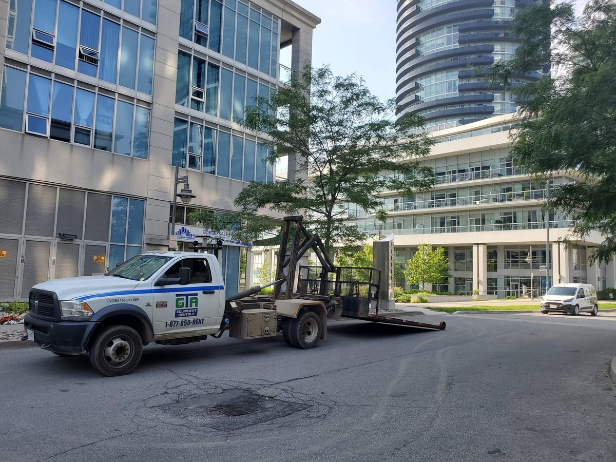 GTA Equipment Rentals truck delivering a scissor lift to a Burlington jobsite