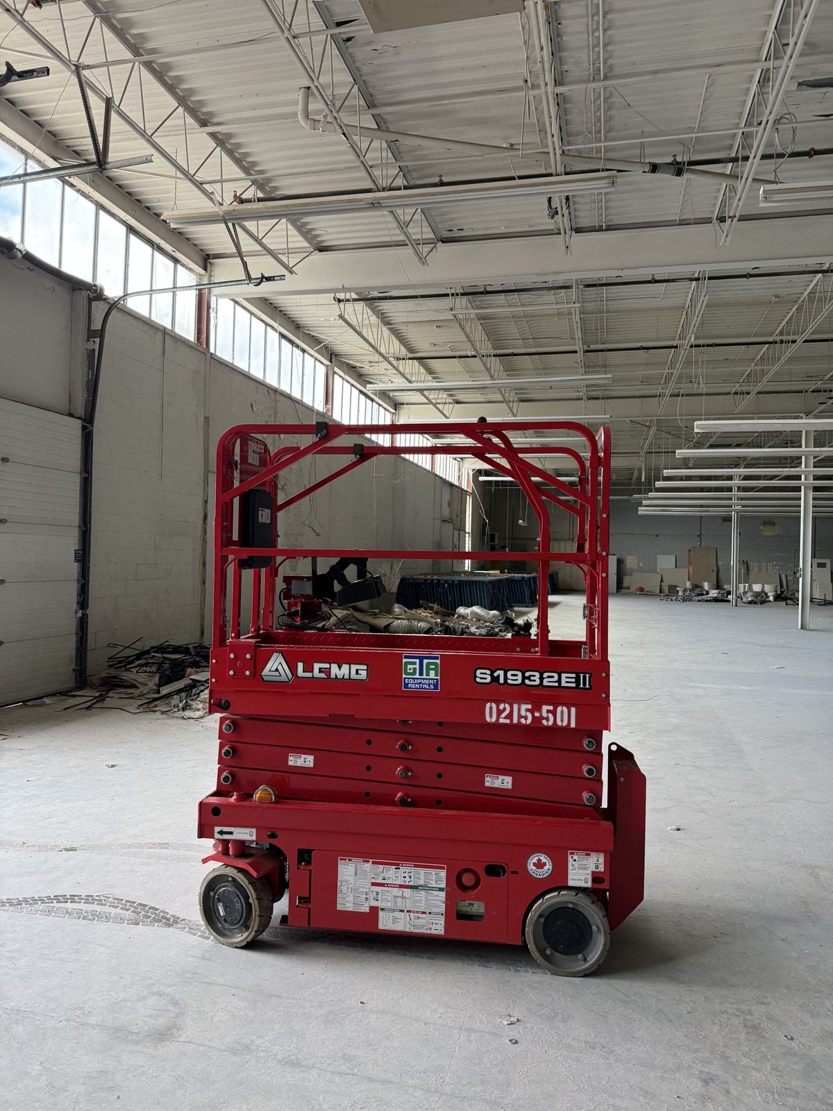 LGMG 1932E2 electric scissor lift from GTA Equipment Rentals raised inside a new warehouse build in the west GTA