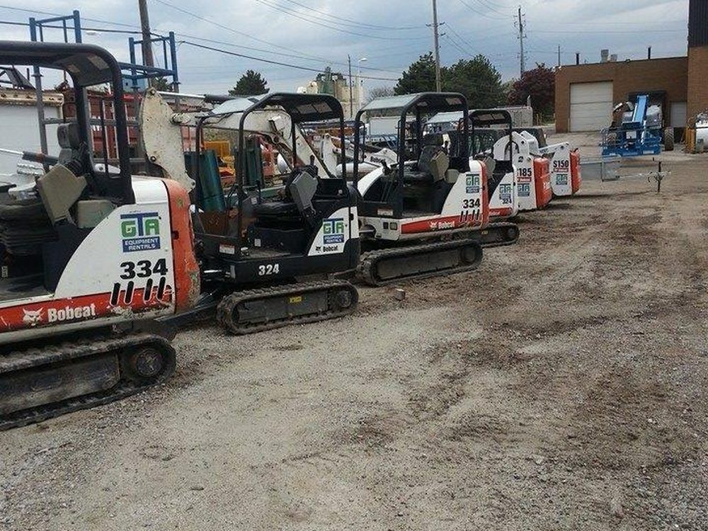 A row of Bobcat excavators lined up in the GTA yard